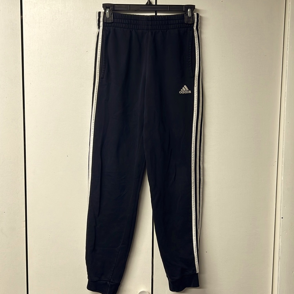 Adidas brand boys joggers with pockets and side stripes.